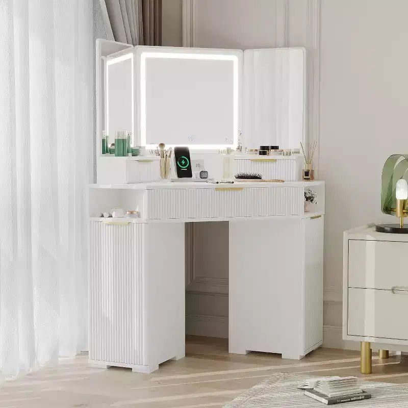 Coiffeuse d'angle avec miroir triptyque et lumières 3 couleurs, table de maquillage cannelée avec station de recharge, tiroirs, armoires de rangement pour chambre à coucher